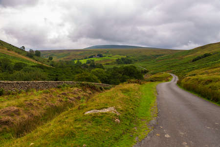 View of the green hills in Yorkshire Dales, Cumbria. Rural landscape, north UK.