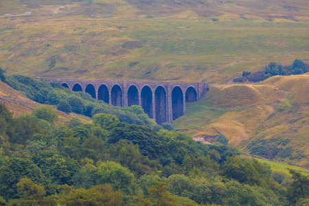 View of the green hills in Yorkshire Dales, Cumbria. Railway viaduct near Dent. Rural landscape, north UK.の写真素材