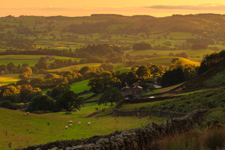 View of the small village Sedbergh. Sunset over green hills in Yorkshire Dales, Cumbria. Rural landscape, north UK.の写真素材