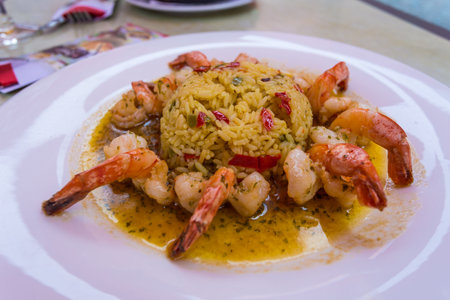 Risotto with hot peppers and prawns served on a white plate.の写真素材