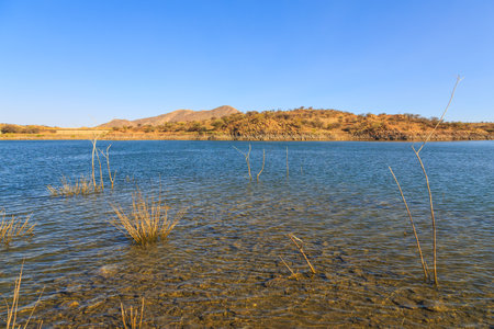 View of the Lake Oanob, an idyllic holiday resort with a lake and a dam near Rehoboth in the Kalahari desert. Namibia.の写真素材