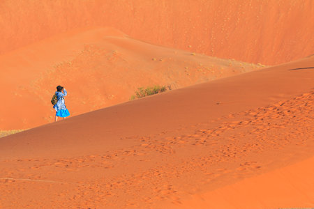 Sossusvlei, Namibia - 29 September 2018: Tourists on the famous dune 45. The southern part of the Namib Desert in the Namib-Naukluft National Park of Namibia.のeditorial素材