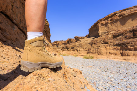 Sesriem, Sossusvlei, Namibia - 30 September 2018: A tourist in the shoes of the renowned Meindl brand. Mountain, climbing and trekking shoes.のeditorial素材