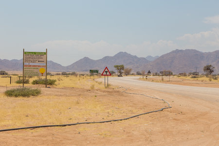 Solitaire, Namibia - October 01, 2018: Gravel road with sign Welcome. Service station at Solitaire in the Namib Desert, Namib-Naukluft National Park.のeditorial素材