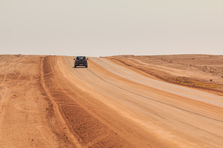Swakopmund, Namibia - October 02, 2018: Car on gravel, namibian road. Namibian wilderness.