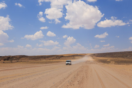 Swakopmund, Namibia - October 02, 2018: Car on gravel, namibian road. Namibian wilderness.のeditorial素材