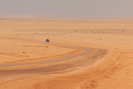 Swakopmund, Namibia - October 02, 2018: Car on gravel, namibian road. Namibian wilderness.のeditorial素材