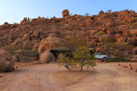 Mowani, Damaraland, Namibia - 04 October 2018: Typical 4x4 rental car in Namibia equipped with camping gear and a roof tent at the campground.のeditorial素材
