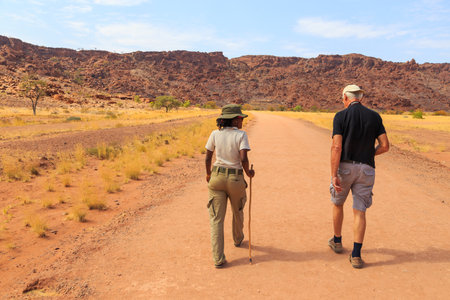 Twyfelfontein, Damaraland, Namibia - 05 October 2018: Tourists in Twyfelfontein, site of ancient rock engravings in the Kunene Region of north-western Namibia. Prehistoric Bushman engravings, rock painting.のeditorial素材