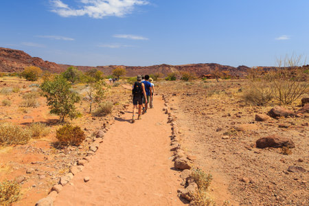 Twyfelfontein, Damaraland, Namibia - 05 October 2018: Tourists in Twyfelfontein, site of ancient rock engravings in the Kunene Region of north-western Namibia. Prehistoric Bushman engravings, rock painting.のeditorial素材
