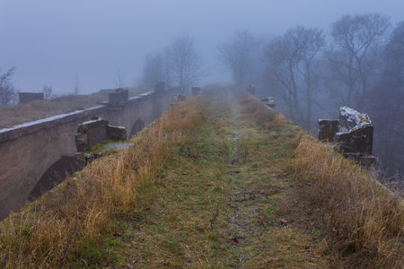 Old concrete railway bridge in Stanczyki. foggy morning. Masuria, Polandの写真素材
