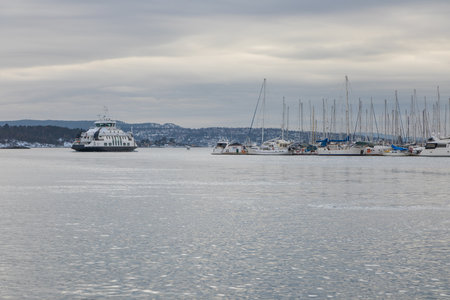 Oslo, Norway - 12 February 2019: Ferries and boats moored off in marina in Oslo. Capital city of Norway.のeditorial素材