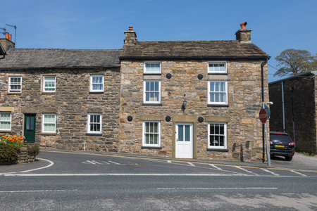 Sedbergh, Yorkshire, UK - 20 April 2019: Facade of a building in the village of Sedbergh . Sunny...