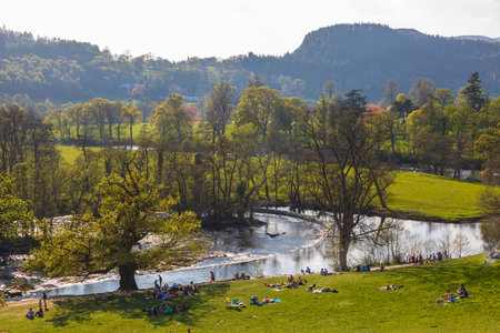 Llangollen, Denbighshire, Wales, UK -21 April 2019: People resting by the Horseshoe Falls near Llangollen.のeditorial素材