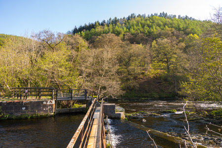Llangollen, Denbighshire, Wales, UK -21 April 2019: People resting by the Horseshoe Falls near Llangollen.のeditorial素材