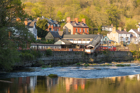 Llangollen, Denbighshire, Wales, UK -21 April 2019: View of the Llangollen town. Brick houses on the River Dee. spring season.のeditorial素材