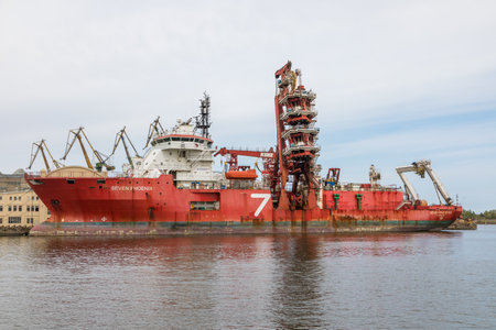 Gdansk, Imperial Shipyard, Poland - 01 May 2019: Ship moored at the quay of the shipyard. Cranes in the background.のeditorial素材