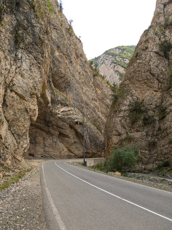 A winding road in a deep gorge. Steep rock walls.Caucasus Mountains, Nagorno-Karabakh, Azerbaijanの写真素材