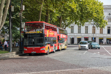 Tbilisi, Georgia - 06 September 2019: Red bus at The Shota Rustaveli Avenue, among the main streets in Tbilisi, Georgia, connecting the Rose Revolution Square to the Liberty.の写真素材