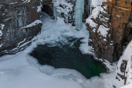 Snowy landscape in winter day time. Mountain river canyon. Abisko National Park, Lapland, Sweden.の写真素材