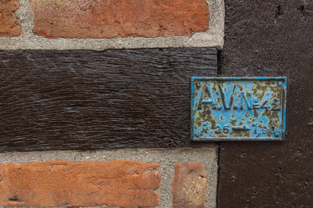 Close-up of a rustic brick wall with dark timber beams, historic architecture in Ystad, Sweden. Detail of facade.の写真素材