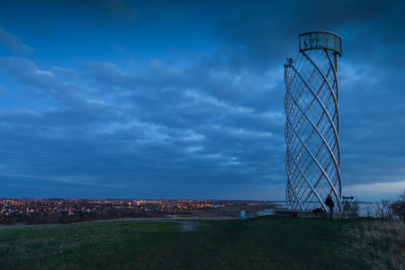 Twilight view of the Lernacken observation tower with city lights below near Oresund, Sweden.の写真素材