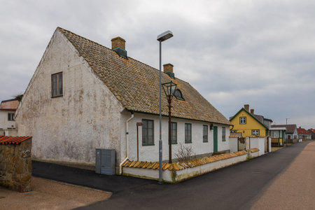 Colorful old houses and a peaceful residential street in the coastal town of Torekov, Sweden.の写真素材