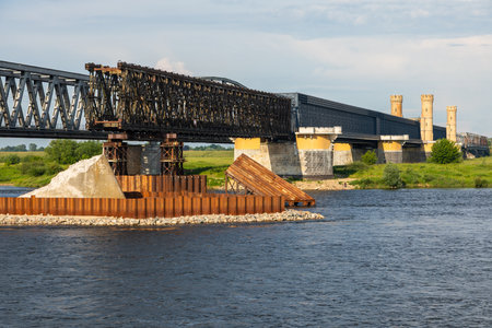 Steel railway bridge with brick towers spans the Vistula River in Tczew, northern Poland.