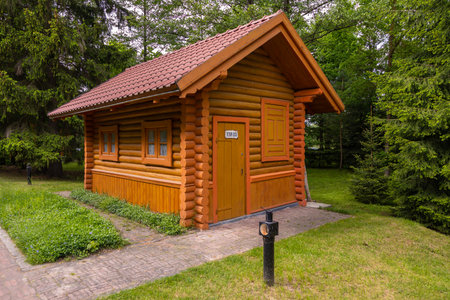 Small wooden cabin surrounded by lush greenery in Bialowieza, Poland - peaceful and cozy.の写真素材