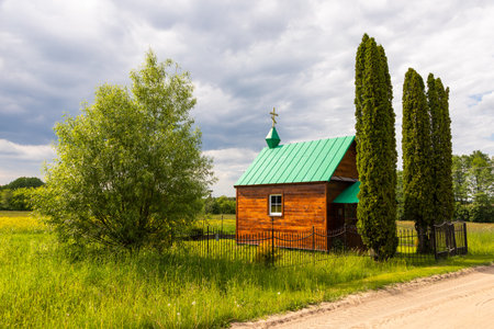 Small Orthodox chapel with green roof surrounded by trees in Soce village, Podlasie, Poland.の写真素材