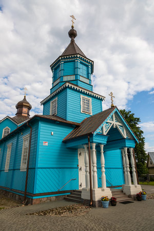 Vibrant blue wooden Orthodox church with traditional architecture in Narew, Podlasie, Poland.の写真素材