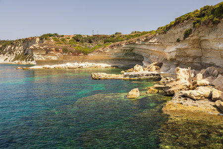 Rocky coastline with turquoise waters and cliffs in Taht Il Maqje, Malta.の写真素材