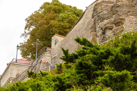 Tallinn, Estonia â September 02, 2021: A historic stone terrace and old building stand atop a limestone cliff with greenery below on a cloudy day.のeditorial素材