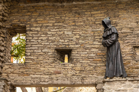 Tallinn, Estonia, 2 September 2021 â close-up of a monk statue on a medieval stone wall in the Old Town.のeditorial素材