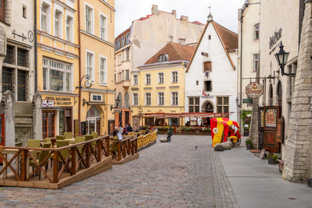 Tallinn, Estonia â September 02, 2021: People walking along an Old Town street lined with historic buildings, cafes and small shops.のeditorial素材