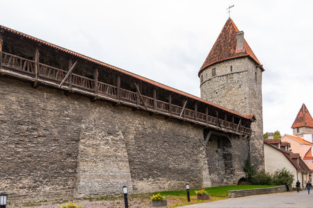 Tallinn, Estonia â September 02, 2021: People walking near a medieval stone wall with towers and a wooden walkway in the Old Town.のeditorial素材