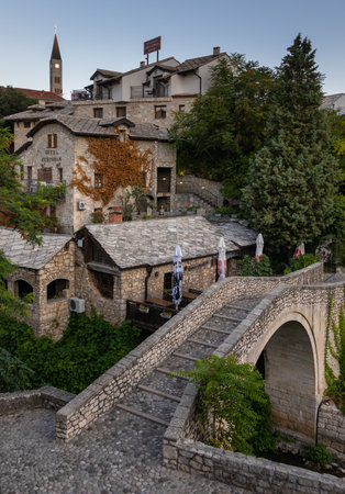 Mostar, Bosnia and Herzegovina, August 17, 2022. View of Kriva Cuprija stone bridge and historic buildings in the old town.のeditorial素材