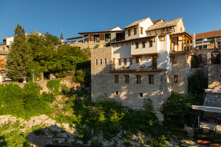 Mostar, Bosnia and Herzegovina â August 17, 2022: Historic stone houses built on a hillside above the old town area of Mostar during daylight.のeditorial素材