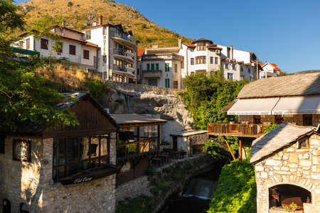 Mostar, Bosnia and Herzegovina â August 17, 2022: Historic stone houses built on a hillside above the old town area of Mostar during daylight.のeditorial素材