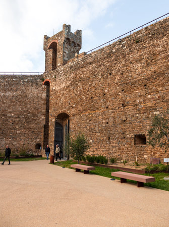 Montalcino, Italy - November 07, 2022: Fortezza di Montalcino in Tuscany, Italy, featuring medieval stone walls, tower, and entrance with people walking.のeditorial素材