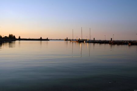 boat against a beautiful sunset in aveiro portugalの写真素材