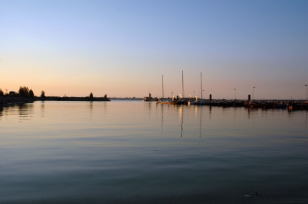 boat against a beautiful sunset in aveiro portugalの写真素材