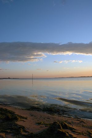 boat against a beautiful sunset in aveiro portugalの写真素材