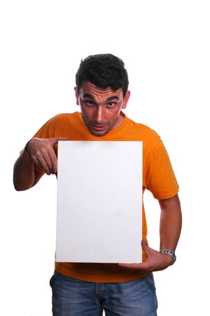 casual guy smiling and pointing at an add below him over whiteの写真素材
