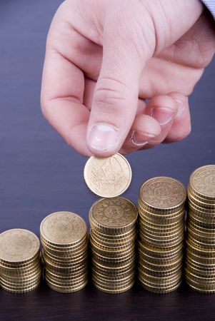 Increase your savings-Hand holding coins against white background