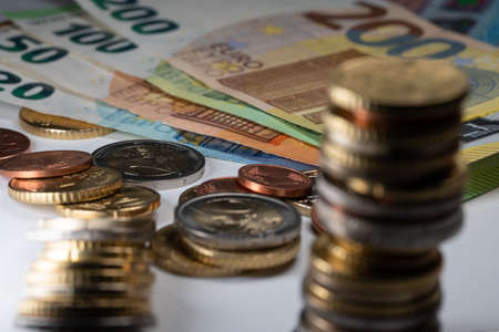 Euro Banknotes from twenty to two hundred Euros. Coins in the foreground out of focusの写真素材