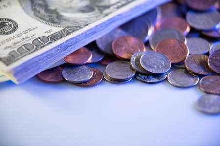 united States Dollar 100 Bill and different coins, cents and quarters to dimes. USA Money on white surfaceの写真素材