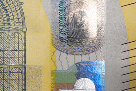 Closeup of 200 Euro Bill. Yellow European Banknote. European Central Bank currency. Hologram on...