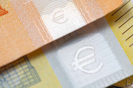 Fifty Euro banknote on two hundred Euro bill, closeup of Hologram safety feature on Euro Money. Colorful Cash from European unionの写真素材