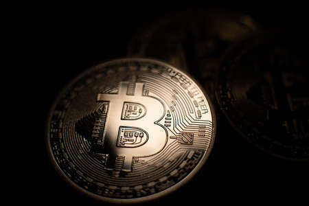 Bitcoin crypto currency in the dark. New Block chain technology. Bitcoin gold coin closeup. Cryptocurrency conceptの写真素材